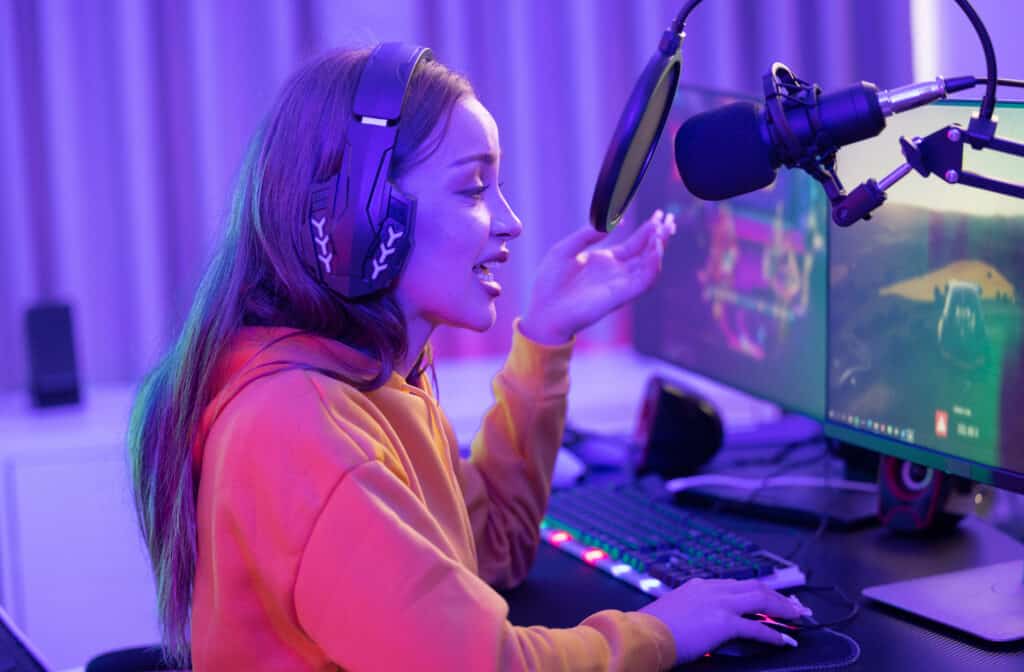 A determined online streamer creates a stream and grows an audience that can generate income through subscriptions and advertising. A contemporary, colorful,  lighted home office.